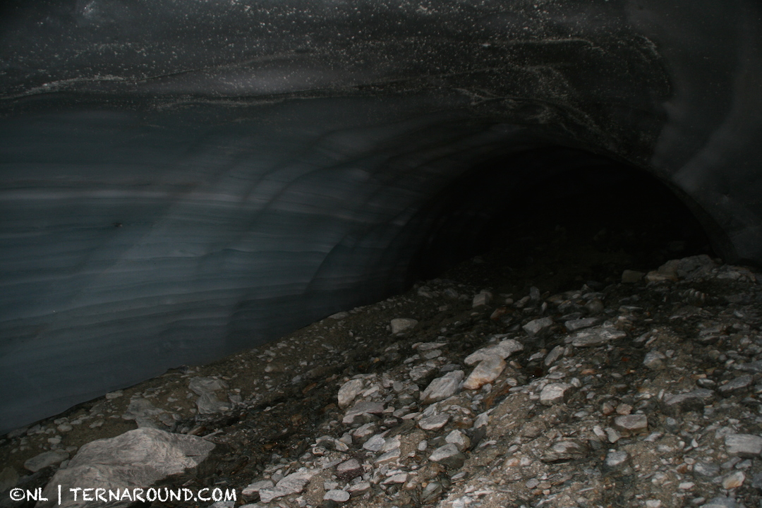 A dark tunnel of beautiful layered ice